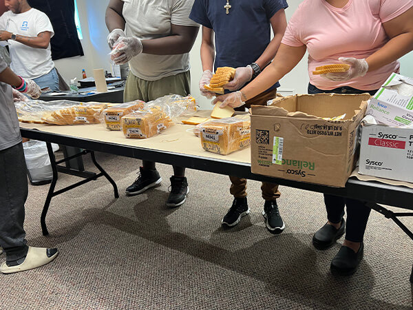 Covenant Home Texas volunteers and youth making sandwiches for homeless kids