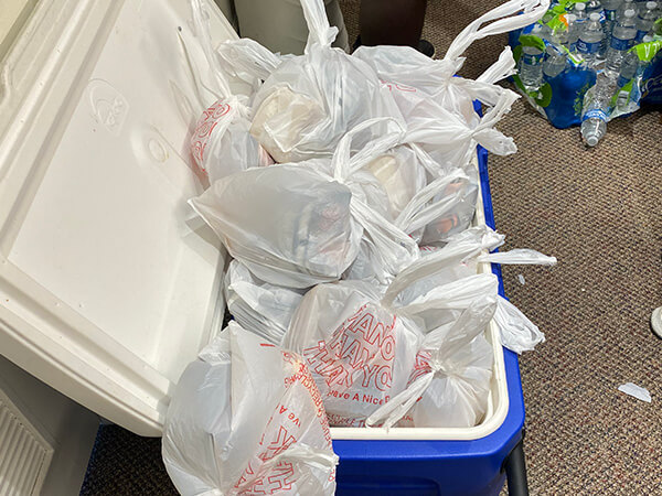 Cooler full of ice for sandwiches being made by volunteers at Covenant Home Texas