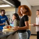 Young lady receiving food in a Covenant Home Cafeteria