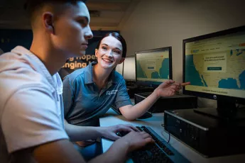 Young man learning about the Covenant Home mission at a computer