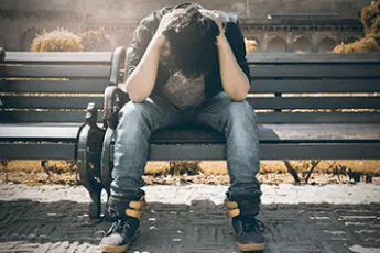 stressed homeless kid on bench | Covenant Home - Gaps in Foster Care