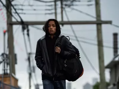 Young man walking outdoors with a backpack