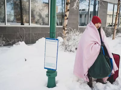 homeless girl outside with blanket and suitcase during the winter | Covenant Home