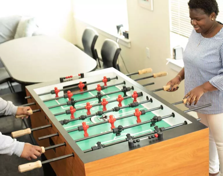 former homeless youth playing foosball | Covenant Home - Philadelphia, Pennsylvania | homeless shelters in philadelphia