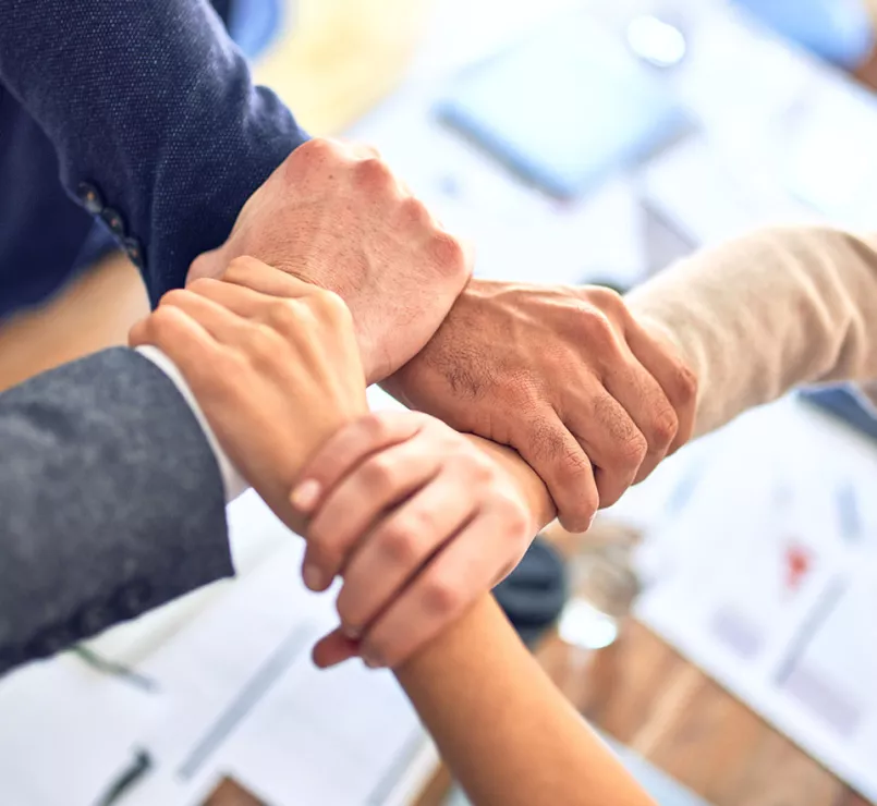 leaders holding each other's wrists symbolizing teamwork | Covenant Home - Leadership