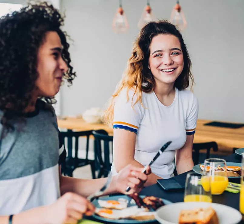 Homeless girls eating breakfast together at a Covenant Home location