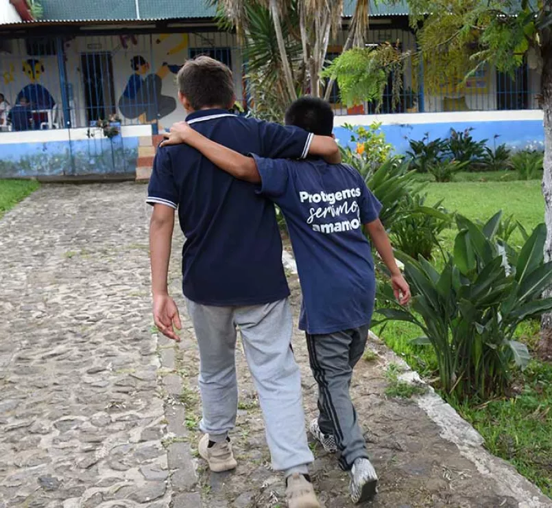 Covenant Home Latin America former homeless youth and staff walking together on a path outside